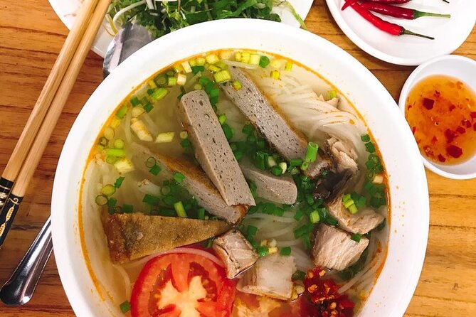 Da Nang Food Tour Motorbike & Sightseeing By Ao Dai Lady Rider - Love Bridge begins the evening beside the Han River
